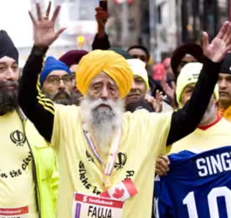 Fauja Singh, the 100-year-old marathoner, running with a beaming smile.